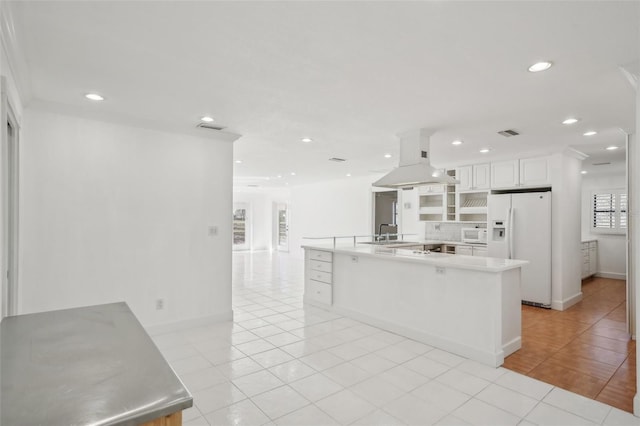 kitchen featuring white appliances, white cabinetry, light countertops, a large island, and island exhaust hood