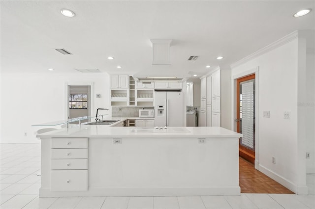 kitchen featuring white appliances, a sink, visible vents, white cabinets, and light countertops