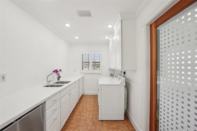 laundry room featuring cabinet space, washer and clothes dryer, ornamental molding, a sink, and recessed lighting