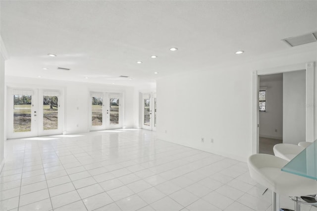 spare room with light tile patterned floors, french doors, visible vents, and recessed lighting