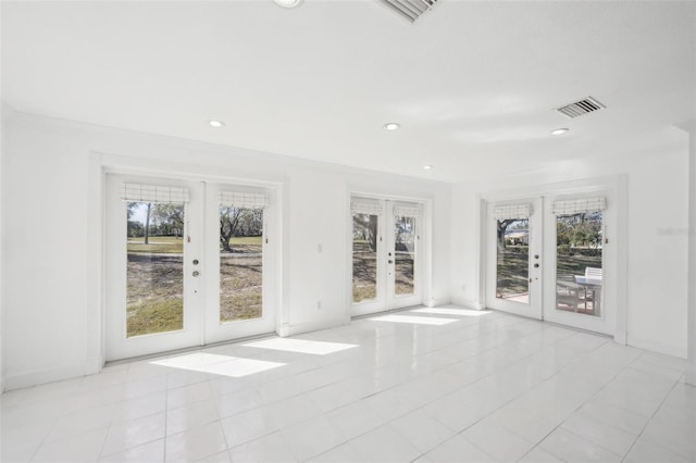 interior space with a wealth of natural light, french doors, visible vents, and recessed lighting