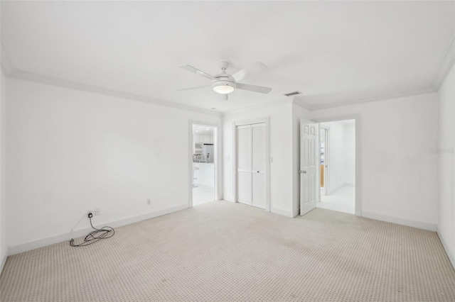 interior space featuring visible vents, baseboards, a ceiling fan, light colored carpet, and ornamental molding