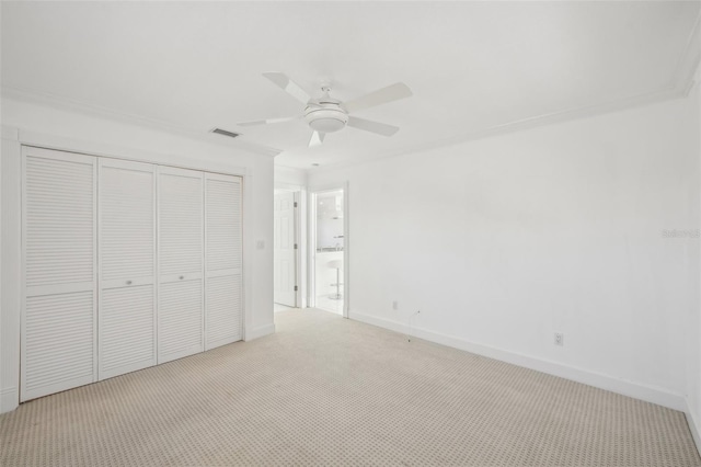 unfurnished bedroom featuring light colored carpet, a ceiling fan, baseboards, visible vents, and a closet