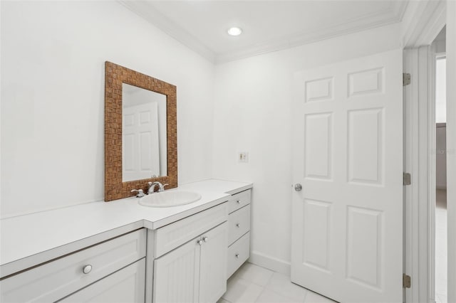 bathroom featuring ornamental molding, vanity, baseboards, and tile patterned floors