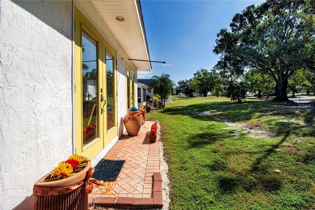 view of yard featuring french doors