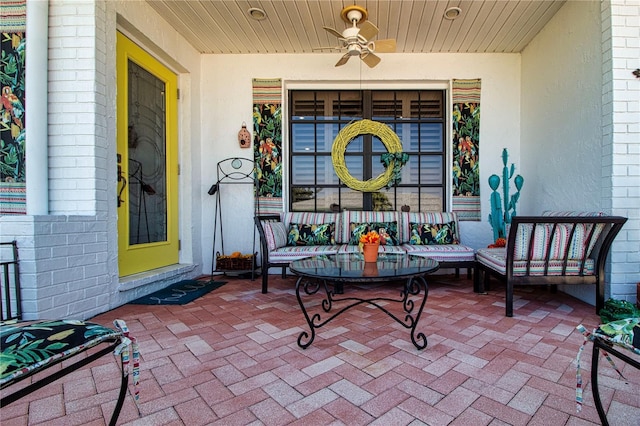 entrance to property featuring brick siding and a ceiling fan