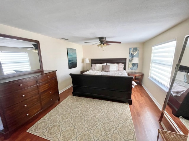 bedroom featuring ceiling fan, a textured ceiling, and hardwood / wood-style flooring