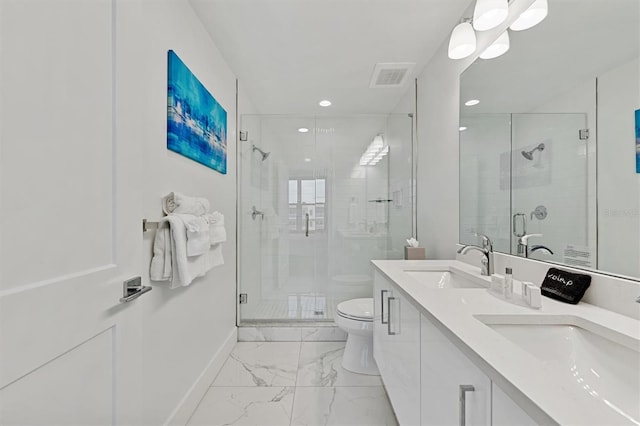 bathroom with double sink, vanity with extensive cabinet space, a shower with door, tile floors, and toilet