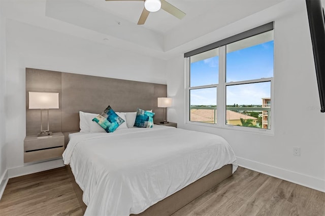 bedroom with ceiling fan and hardwood / wood-style flooring