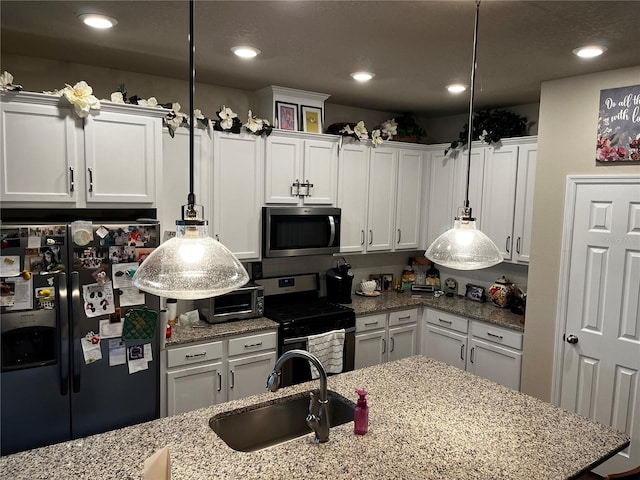 kitchen with white cabinetry, sink, light stone countertops, and stainless steel appliances