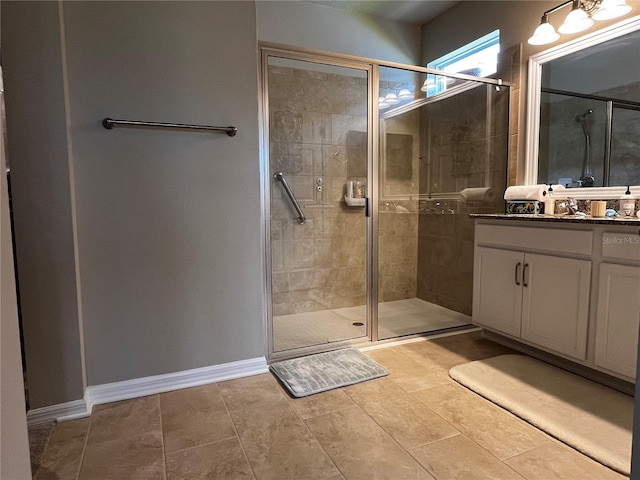 bathroom with tile floors, an enclosed shower, and vanity