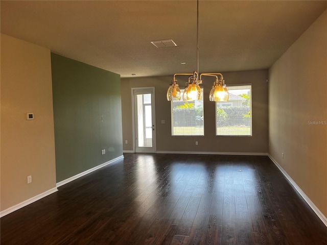 unfurnished dining area featuring a wealth of natural light, dark wood finished floors, and baseboards