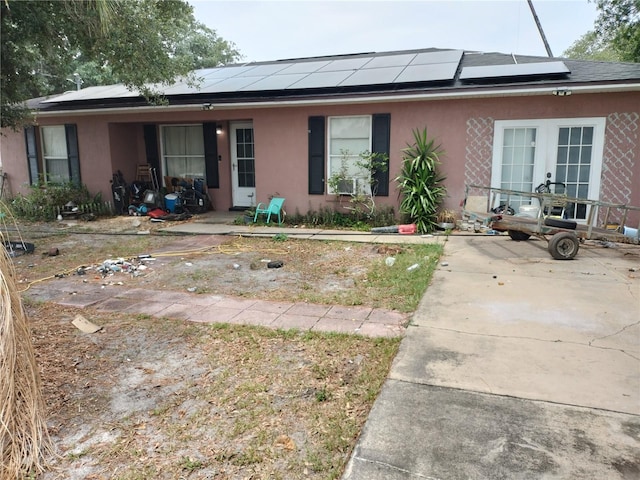 back of property featuring solar panels