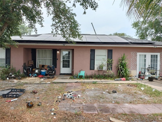 single story home featuring a patio area and solar panels