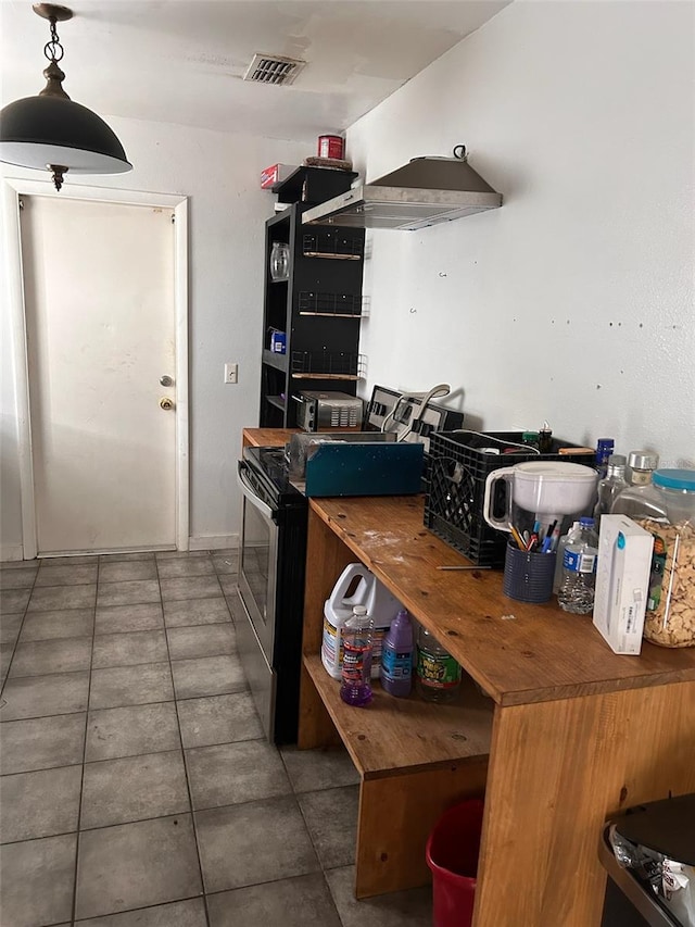 kitchen with double oven range and tile flooring