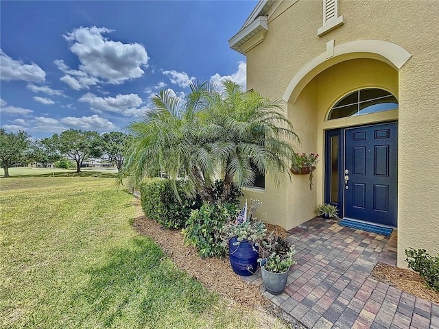 doorway to property with a yard