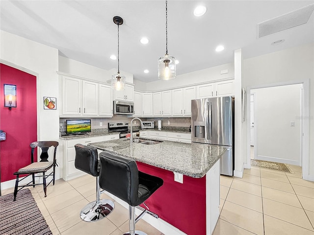 kitchen featuring stainless steel appliances, tasteful backsplash, pendant lighting, and light tile floors