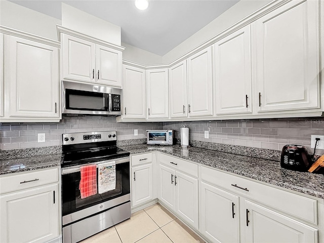 kitchen with stainless steel appliances, white cabinetry, tasteful backsplash, and light tile floors