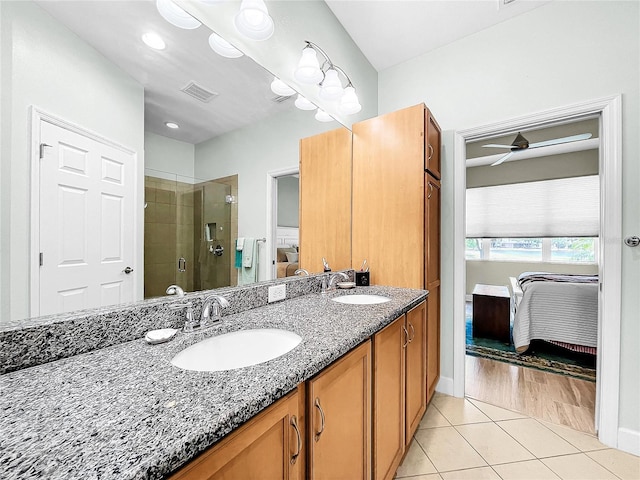 bathroom with dual sinks, ceiling fan, wood-type flooring, walk in shower, and large vanity