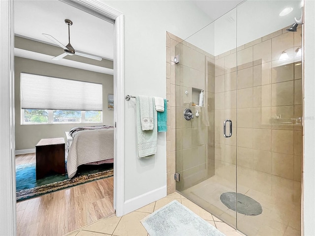 bathroom featuring a shower with door, ceiling fan, and hardwood / wood-style floors