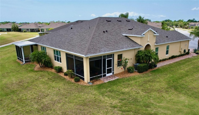 back of house featuring a sunroom and a yard