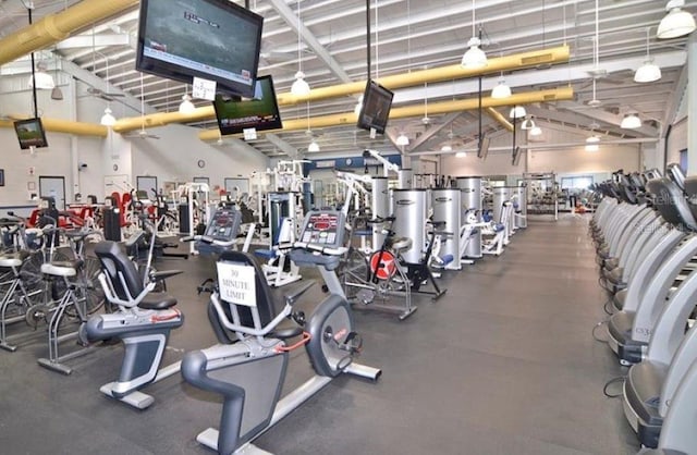 exercise room with high vaulted ceiling