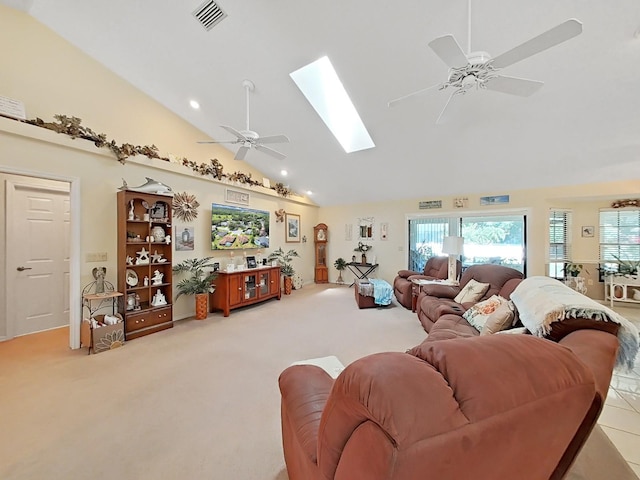 carpeted living room featuring high vaulted ceiling, ceiling fan, and a skylight