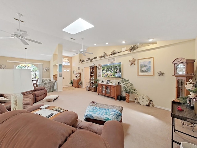 carpeted living room featuring lofted ceiling with skylight and ceiling fan