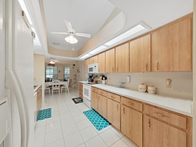 kitchen with ceiling fan, light brown cabinetry, white appliances, and light tile floors