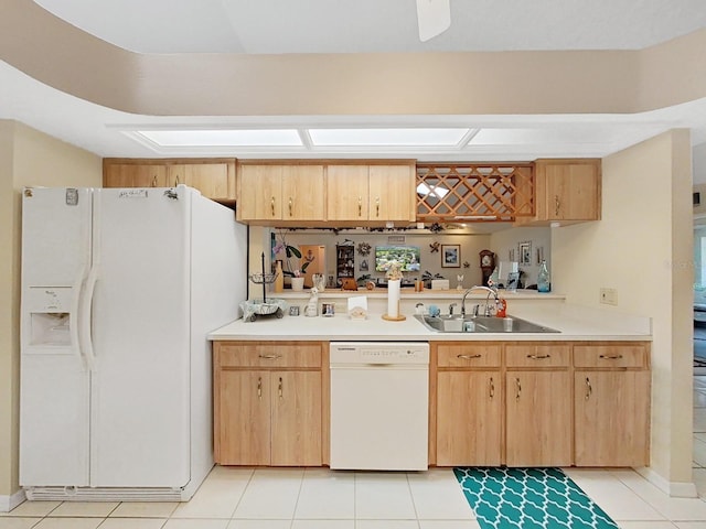 kitchen featuring sink, white appliances, light brown cabinetry, and light tile floors