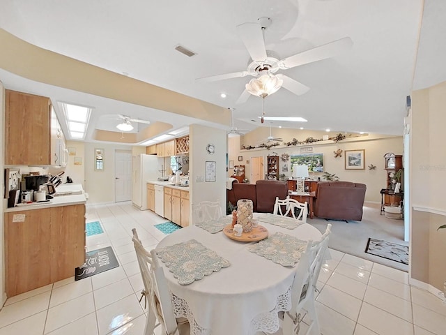 dining space featuring vaulted ceiling, ceiling fan, and light tile floors