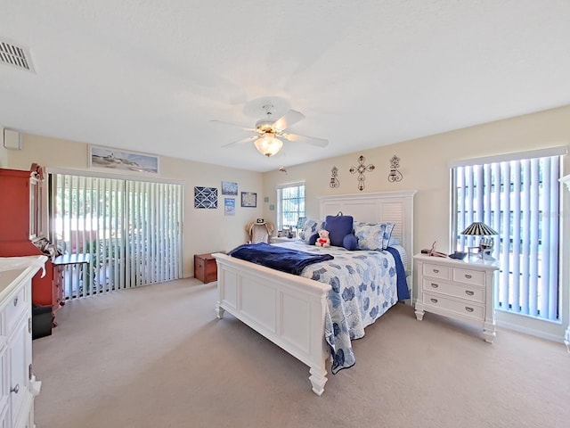 bedroom featuring light carpet and ceiling fan