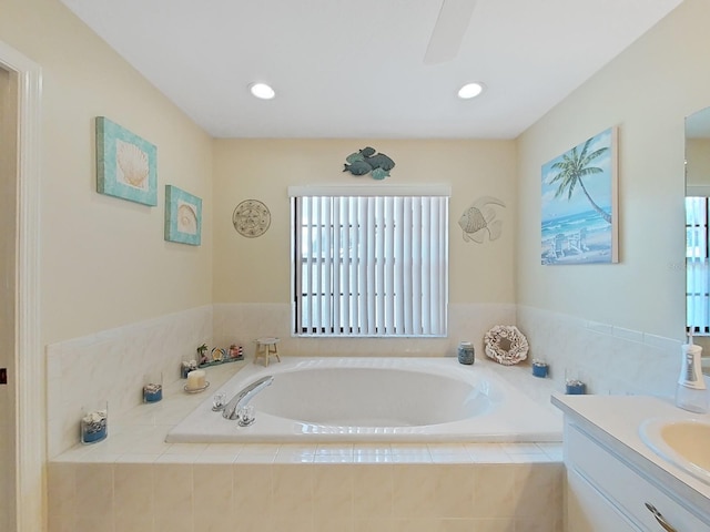 bathroom with a relaxing tiled bath and vanity