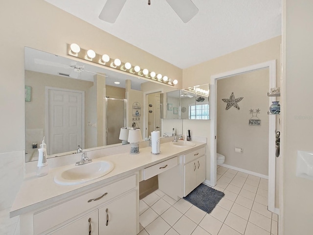 bathroom featuring dual sinks, ceiling fan, tile floors, toilet, and large vanity