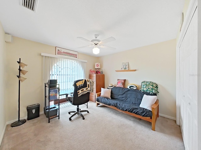 carpeted bedroom featuring ceiling fan and a closet