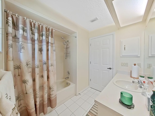 bathroom featuring tile flooring, shower / tub combo, a textured ceiling, and vanity with extensive cabinet space