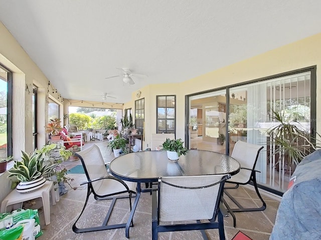 sunroom with plenty of natural light and ceiling fan