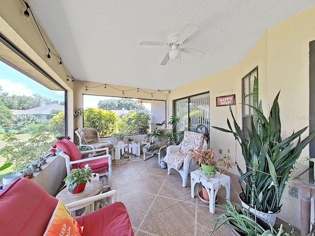 sunroom featuring ceiling fan