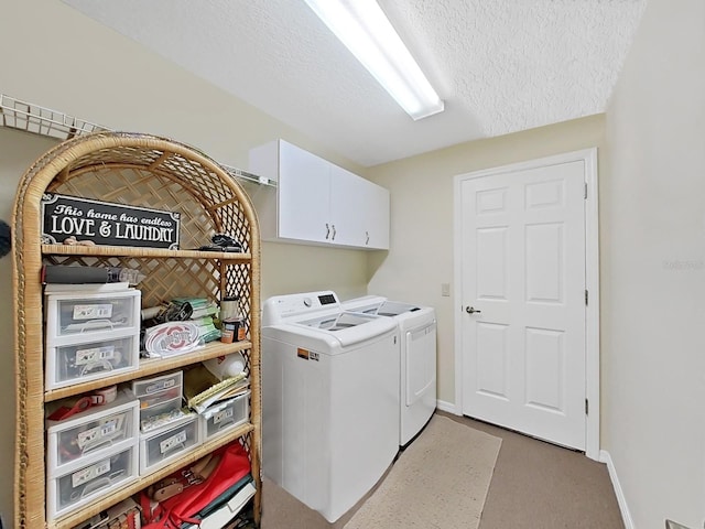 washroom with separate washer and dryer, a textured ceiling, and cabinets