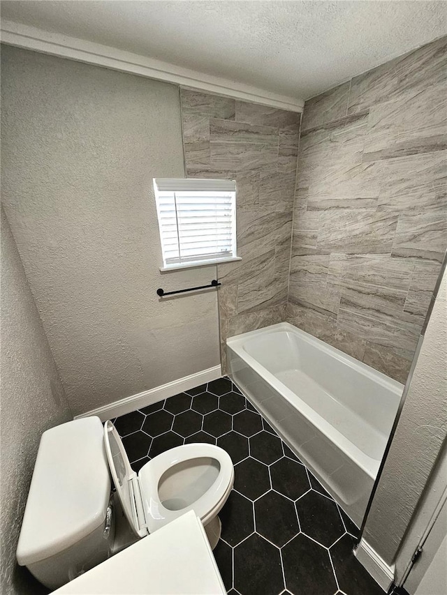 bathroom featuring tile flooring, a textured ceiling, and toilet