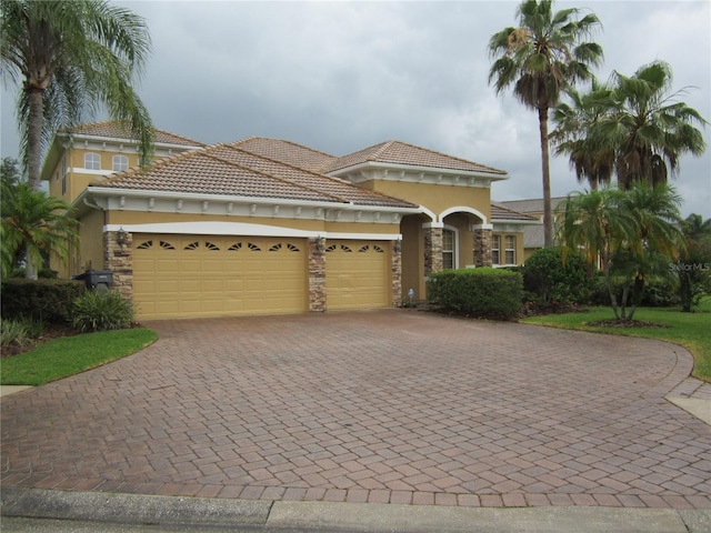 mediterranean / spanish house with a garage