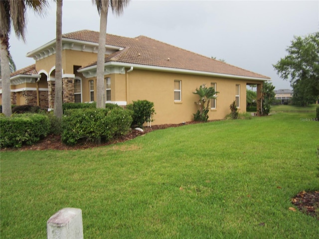 back of house with a lawn