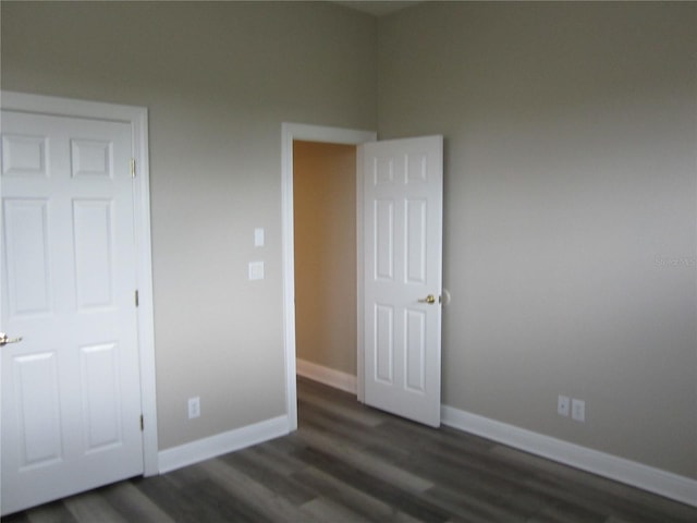 unfurnished bedroom featuring dark wood-type flooring