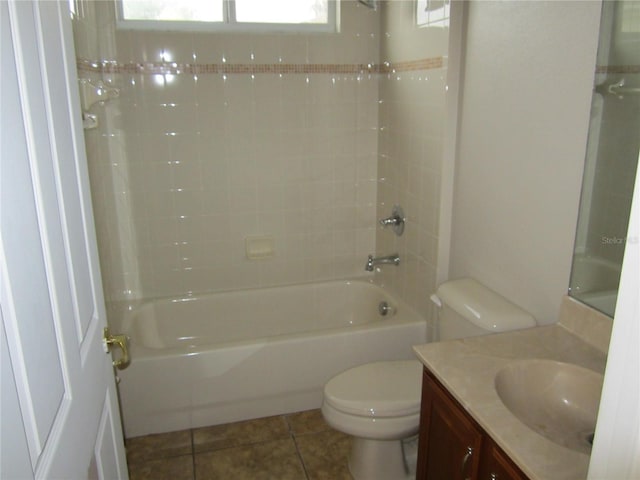 full bathroom featuring tile floors, tiled shower / bath, toilet, and large vanity