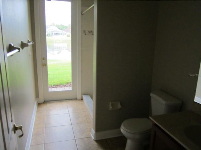 bathroom with tile flooring, vanity, and toilet