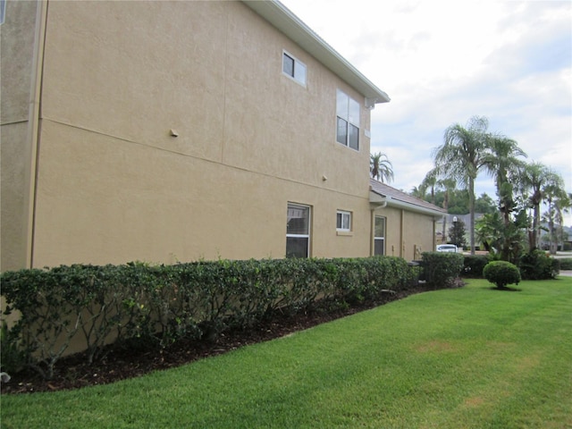 view of home's exterior with a yard