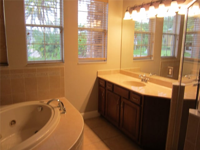 bathroom with tile flooring, vanity, and a bathing tub