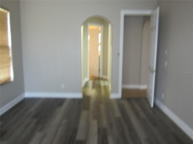 unfurnished room featuring dark hardwood / wood-style flooring