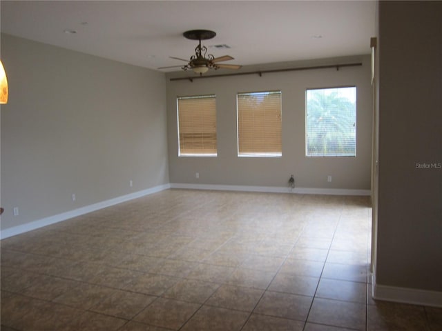 tiled empty room with ceiling fan