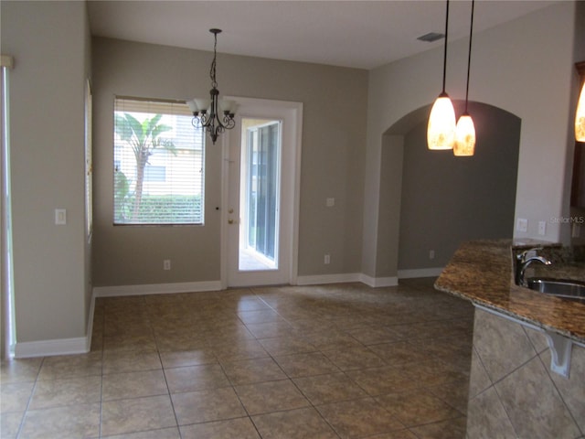 interior space with sink, tile flooring, and an inviting chandelier